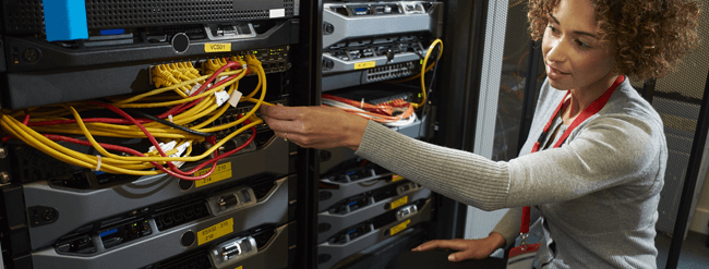 Technician tending to network hardware.