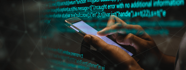 Someone using a phone with screen of code in the background.