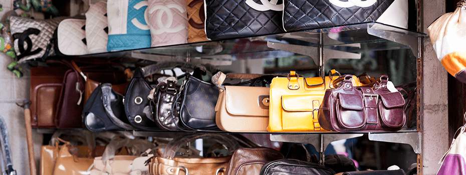 Display shelf lined with various purses