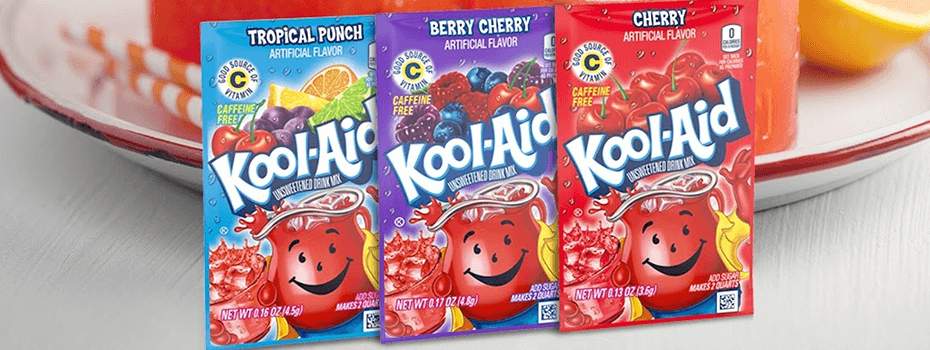 Three packets of various Kool-Aid in front of serving dish