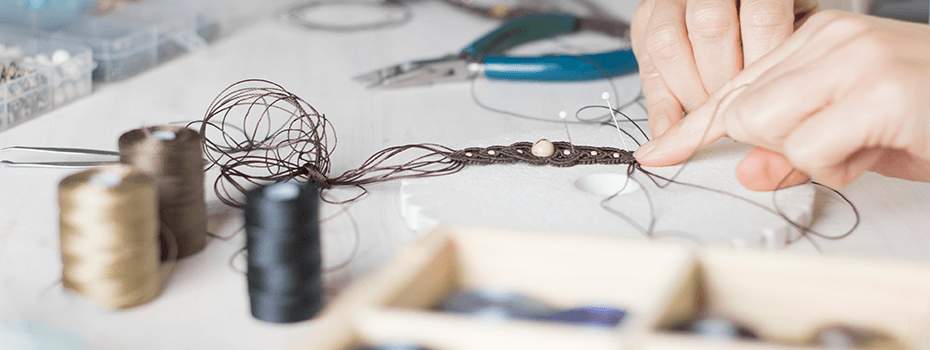 Jewelry artist making a pendant from wire