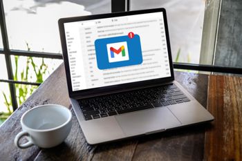 Gmail on a laptop next to a coffee cup